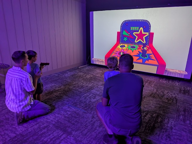 A family enjoying an interactive experience inside an actual HSSC Private Range Suite