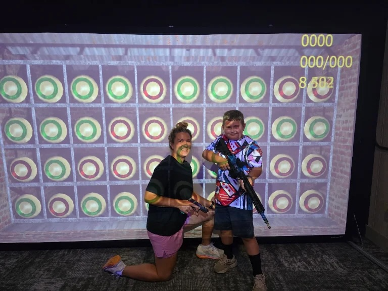 Mother and son enjoying the plate-grid challenge in an HSSC simulator Suite.
